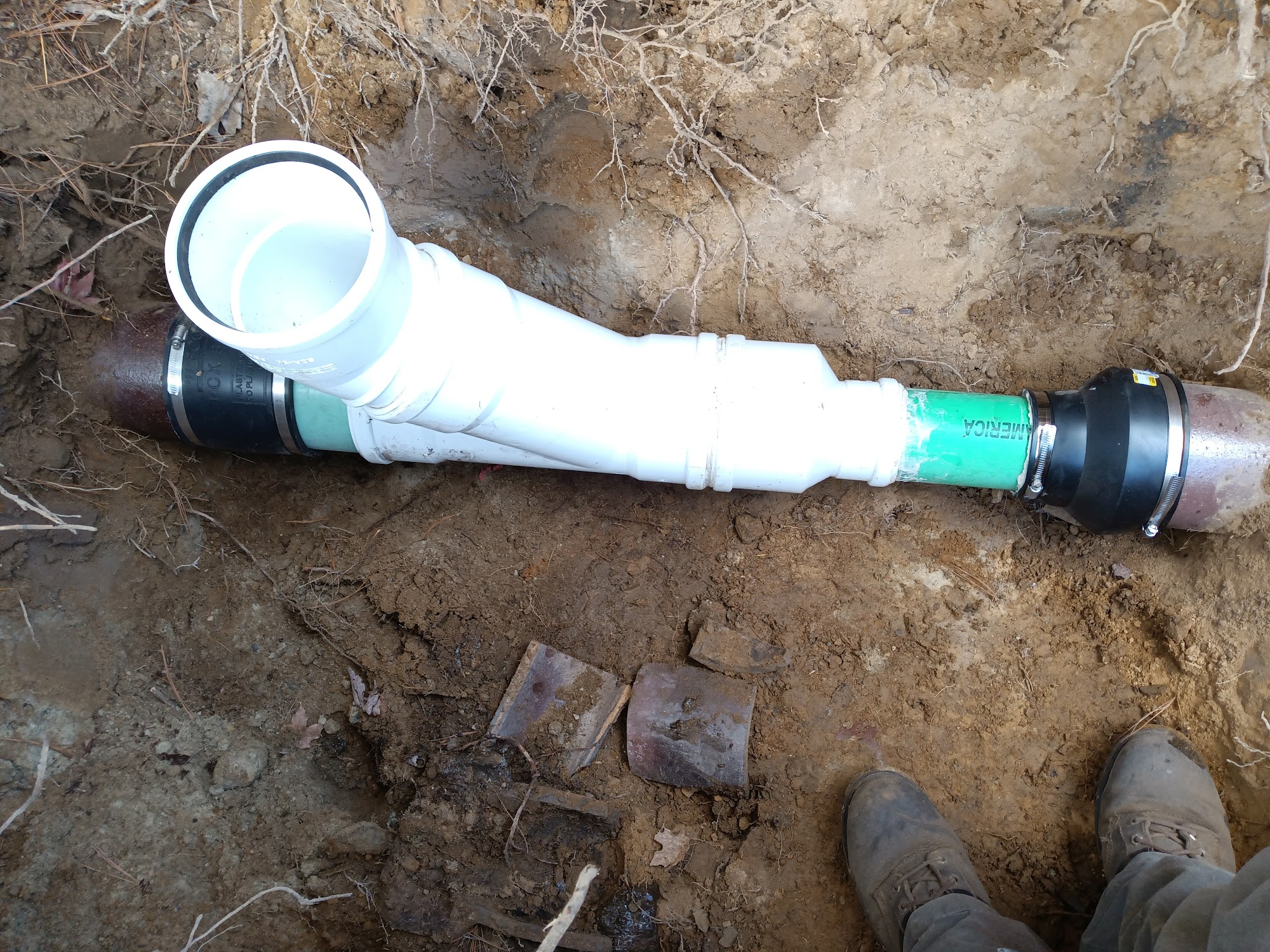 New PVC wye fitting connecting to existing clay pipe